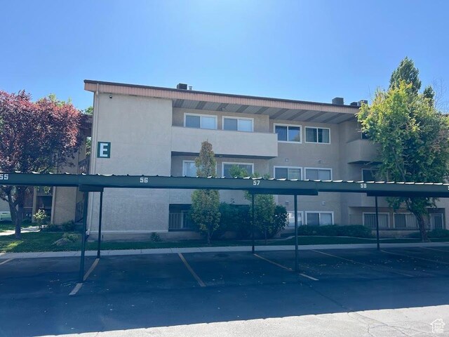 1809 W 7600 S Unit E303, West Jordan, UT 84084 - view of property with covered parking