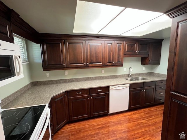 1809 W 7600 S Unit E303, West Jordan, UT 84084 - kitchen featuring white appliances, dark brown cabinets, and light wood finished floors