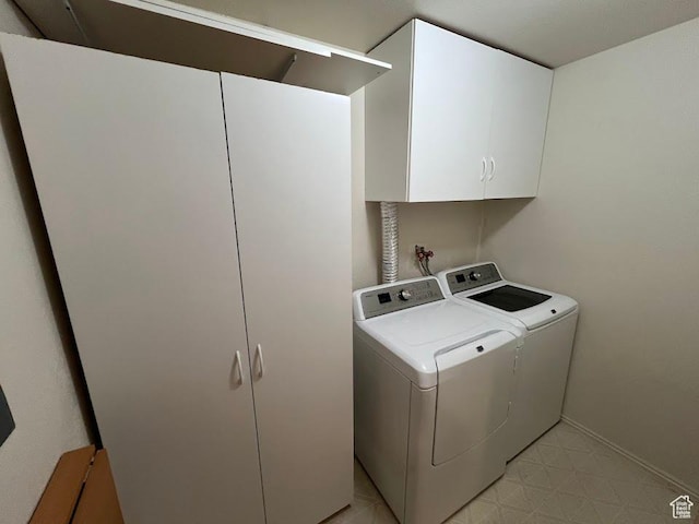 1809 W 7600 S Unit E303, West Jordan, UT 84084 - laundry area with cabinet space, washer and clothes dryer, and light floors