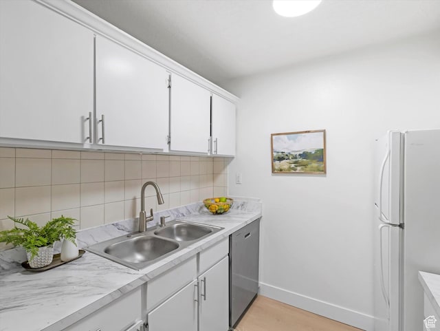5561 S Willow Ln Unit C, Murray, UT 84107 - kitchen featuring freestanding refrigerator, stainless steel dishwasher, backsplash, light countertops, and white cabinets