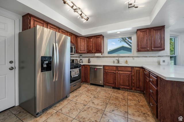 859 E 200 N, Orem, UT 84097 - kitchen featuring stainless steel appliances, decorative backsplash, light countertops, a peninsula, and a raised ceiling