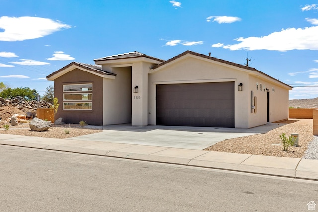 169 N 3670 W, Hurricane, UT 84737 - view of front facade featuring an attached garage, stucco siding, driveway, and a tiled roof
