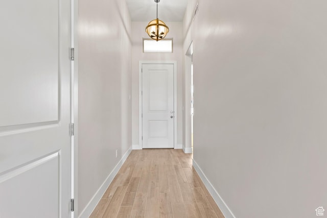 169 N 3670 W, Hurricane, UT 84737 - hallway with light wood-style flooring and a chandelier