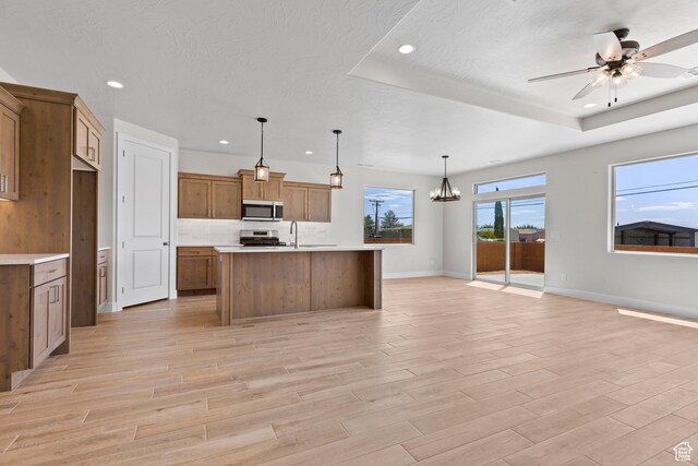 169 N 3670 W, Hurricane, UT 84737 - kitchen featuring appliances with stainless steel finishes, open floor plan, recessed lighting, light countertops, and light wood-style floors