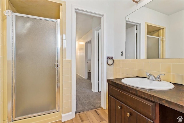 7459 W 3100 S, Magna, UT 84044 - full bathroom with vanity, a stall shower, wood finished floors, and decorative backsplash
