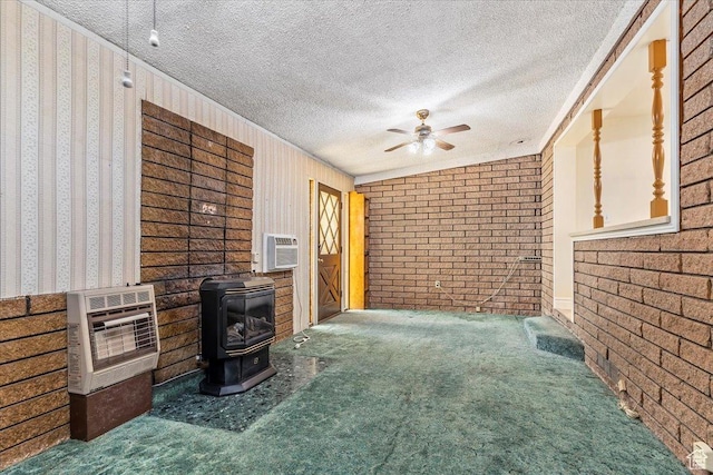 7459 W 3100 S, Magna, UT 84044 - living room featuring heating unit, a wood stove, carpet, ceiling fan, and a textured ceiling