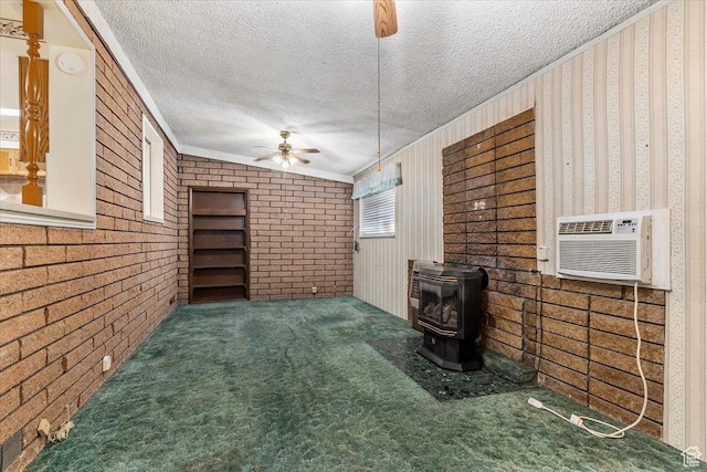 7459 W 3100 S, Magna, UT 84044 - unfurnished living room with ceiling fan, a wood stove, a textured ceiling, ornamental molding, and carpet floors