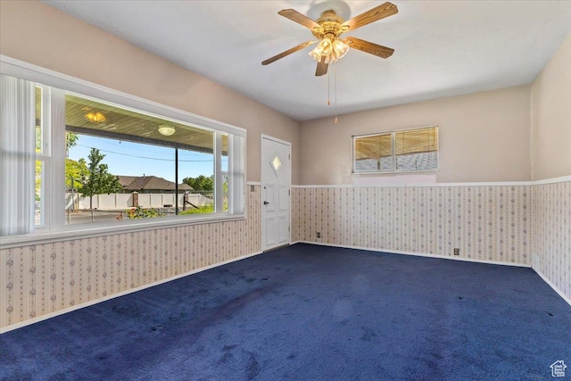 7459 W 3100 S, Magna, UT 84044 - empty room featuring wallpapered walls, a wainscoted wall, dark colored carpet, and a ceiling fan