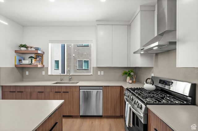 765 N 400 W Unit 205, Salt Lake City, UT 84103 - kitchen featuring stainless steel appliances, wall chimney exhaust hood, modern cabinets, white cabinets, and light countertops