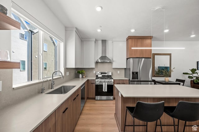 765 N 400 W Unit 205, Salt Lake City, UT 84103 - kitchen with stainless steel appliances, wall chimney exhaust hood, modern cabinets, a kitchen breakfast bar, and light countertops
