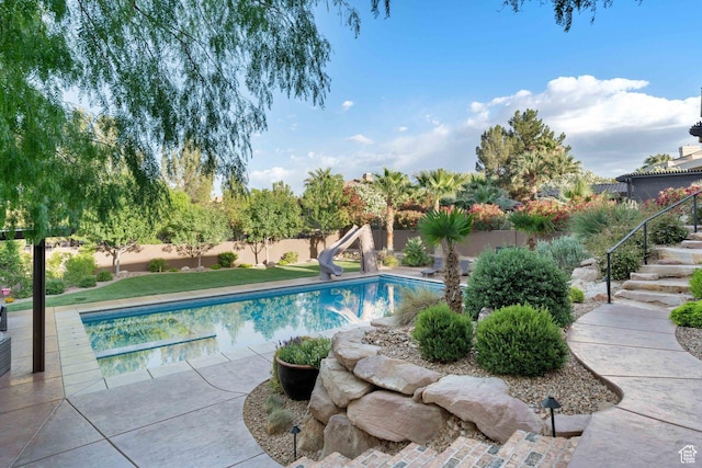 1557 S Stone Cliff Dr, St George, UT 84790 - swimming pool with a water slide, a fenced backyard, and stairway
