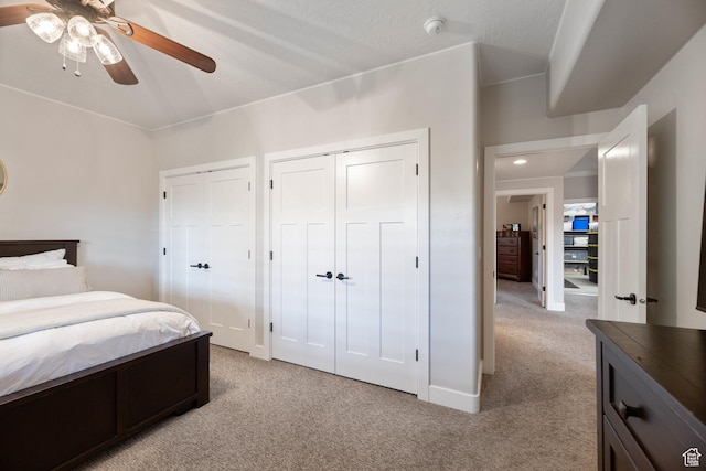 1557 S Stone Cliff Dr, St George, UT 84790 - bedroom with light carpet, two closets, and a ceiling fan