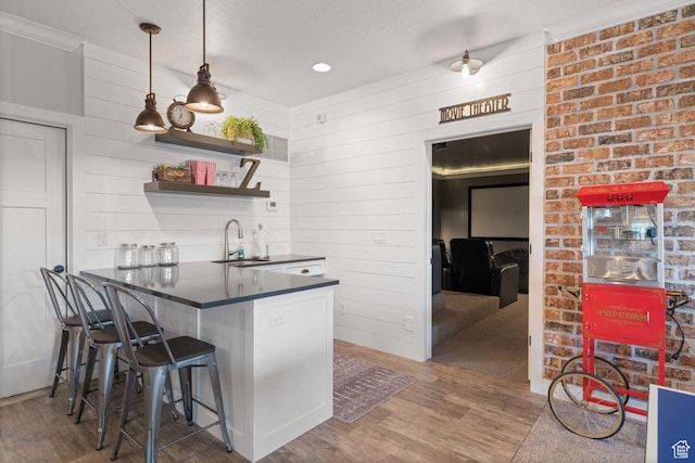 1557 S Stone Cliff Dr, St George, UT 84790 - kitchen featuring dark countertops, wood finished floors, a breakfast bar, pendant lighting, and open shelves