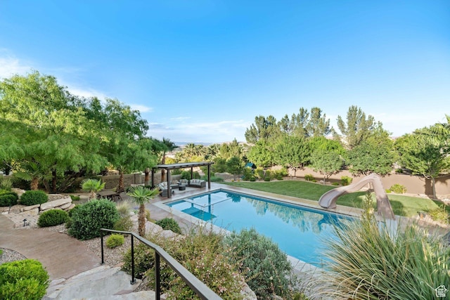 1557 S Stone Cliff Dr, St George, UT 84790 - outdoor pool with a water slide, a patio, and a fenced backyard