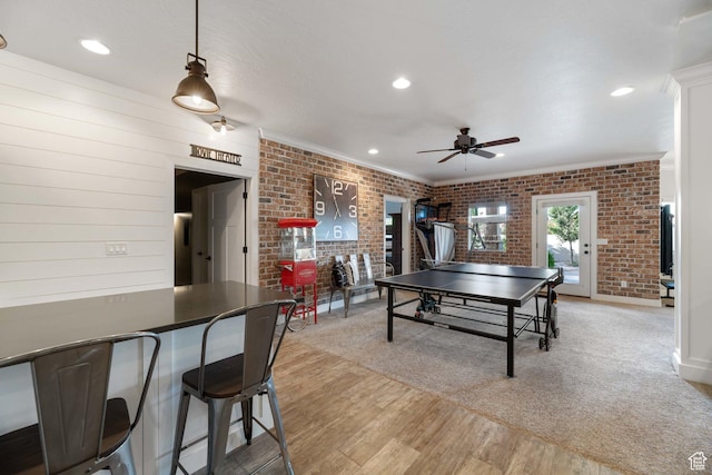1557 S Stone Cliff Dr, St George, UT 84790 - playroom with ceiling fan, brick wall, crown molding, light wood-type flooring, and recessed lighting