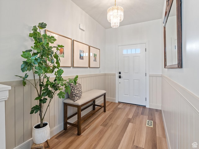 2148 E 970 N, Spanish Fork, UT 84660 - entrance foyer with light wood finished floors, a wainscoted wall, a chandelier, and a decorative wall
