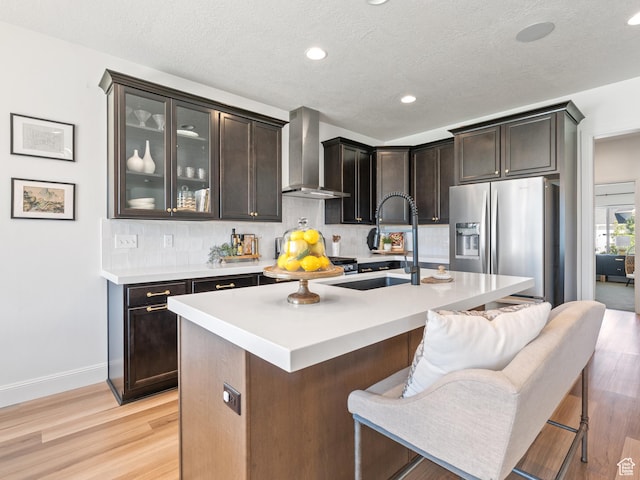 2148 E 970 N, Spanish Fork, UT 84660 - kitchen with stainless steel refrigerator with ice dispenser, wall chimney range hood, backsplash, light countertops, and recessed lighting