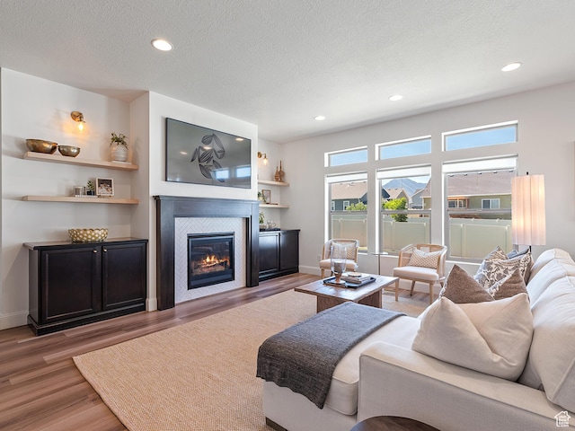 2148 E 970 N, Spanish Fork, UT 84660 - living area featuring wood finished floors, a fireplace, recessed lighting, and a textured ceiling