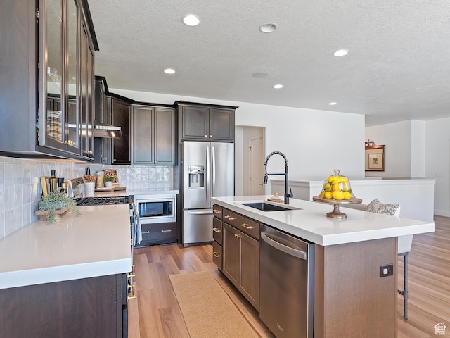 2148 E 970 N, Spanish Fork, UT 84660 - kitchen featuring appliances with stainless steel finishes, light countertops, a textured ceiling, a breakfast bar area, and backsplash