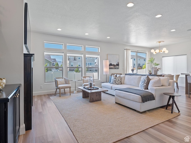 2148 E 970 N, Spanish Fork, UT 84660 - living area with a textured ceiling, a chandelier, light wood-style floors, healthy amount of natural light, and recessed lighting
