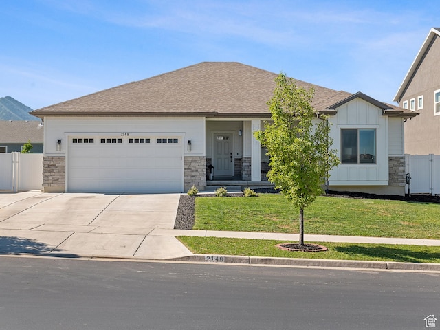 2148 E 970 N, Spanish Fork, UT 84660 - view of front of home with stone siding, a garage, and concrete driveway