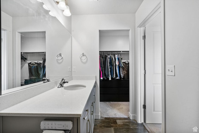 655 W 1430 S, Orem, UT 84058 - bathroom featuring vanity, a spacious closet, and wood finished floors