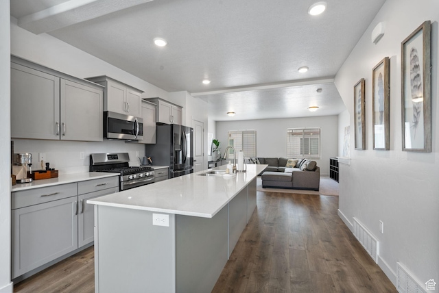 655 W 1430 S, Orem, UT 84058 - kitchen with appliances with stainless steel finishes, gray cabinets, a kitchen island with sink, dark wood finished floors, and open floor plan