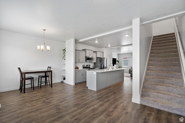 655 W 1430 S, Orem, UT 84058 - kitchen featuring appliances with stainless steel finishes, gray cabinetry, light countertops, dark wood finished floors, and a chandelier