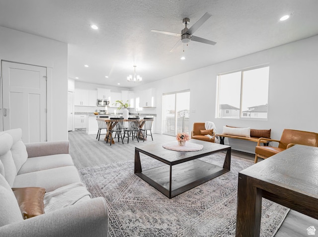 3705 W Chalgrove Rd, Taylor, UT 84401 - living room with recessed lighting, a chandelier, ceiling fan, and light wood-style flooring