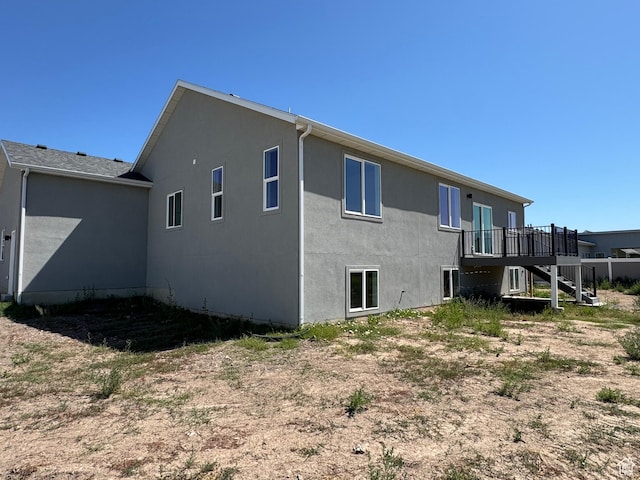 3705 W Chalgrove Rd, Taylor, UT 84401 - rear view of house featuring stairs, stucco siding, and a deck