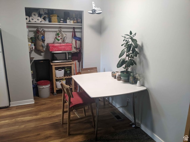 173 N K St E, Salt Lake City, UT 84103 - dining area featuring baseboards and wood finished floors