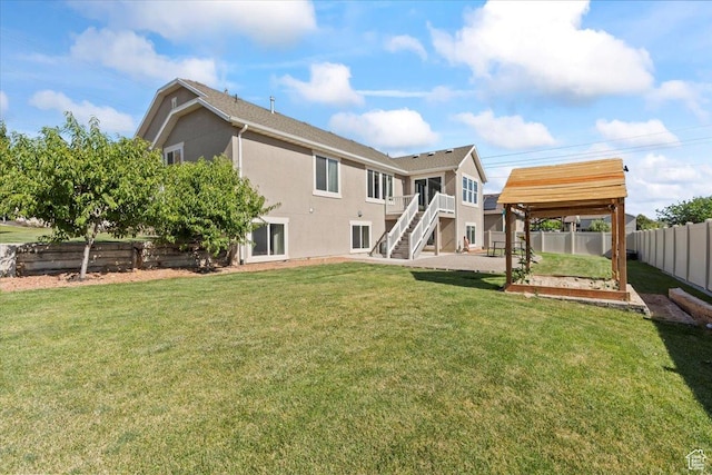 1608 S Terrace Rd, Saratoga Springs, UT 84045 - back of house with a vegetable garden, stairs, and stucco siding