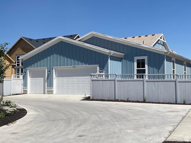 6511 W Lake Ave, South Jordan, UT 84009 - view of front of home featuring an attached garage, board and batten siding, and driveway