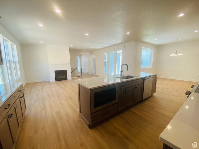 6511 W Lake Ave, South Jordan, UT 84009 - kitchen with stainless steel appliances, a fireplace, light wood-type flooring, plenty of natural light, and recessed lighting