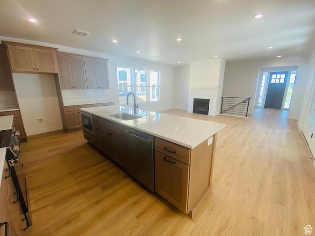 6511 W Lake Ave, South Jordan, UT 84009 - kitchen with stainless steel appliances, light wood-style floors, tasteful backsplash, light countertops, and recessed lighting