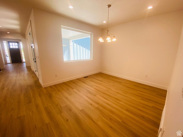 6511 W Lake Ave, South Jordan, UT 84009 - unfurnished room featuring wood finished floors, a chandelier, and recessed lighting