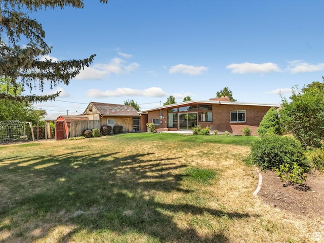 2848 E Loran Heights Dr, Millcreek, UT 84109 - rear view of house with a storage shed and brick siding