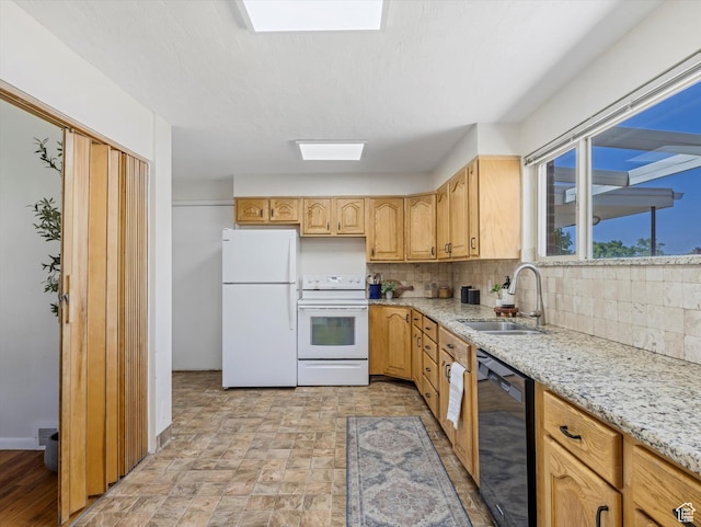 2848 E Loran Heights Dr, Millcreek, UT 84109 - kitchen with white appliances, a skylight, decorative backsplash, light stone counters, and stone finish flooring