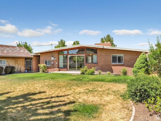 2848 E Loran Heights Dr, Millcreek, UT 84109 - rear view of property featuring brick siding, a lawn, and a chimney