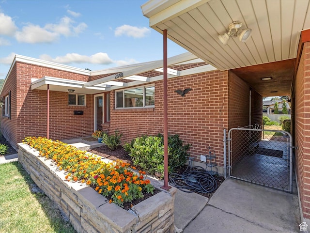 2848 E Loran Heights Dr, Millcreek, UT 84109 - view of side of home featuring brick siding and a gate