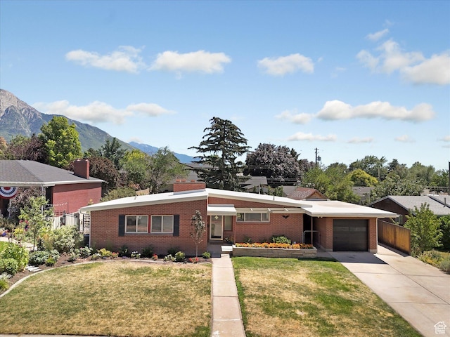 2848 E Loran Heights Dr, Millcreek, UT 84109 - view of front of property featuring an attached garage, brick siding, concrete driveway, and a mountain view