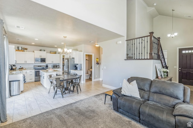 150 N 1100 E Unit 63, Washington, UT 84780 - living room with a chandelier, stairs, a towering ceiling, and recessed lighting