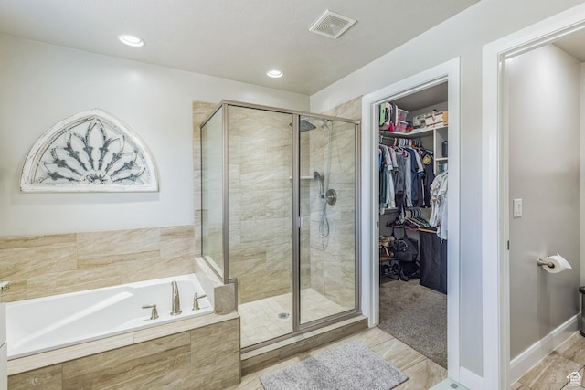 150 N 1100 E Unit 63, Washington, UT 84780 - bathroom featuring a garden tub, a shower stall, a walk in closet, and recessed lighting