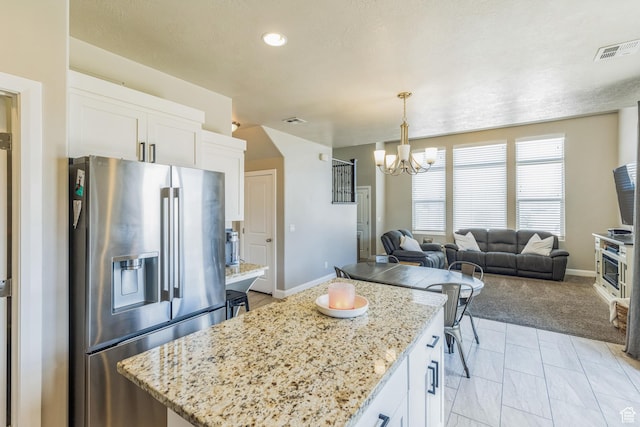 150 N 1100 E Unit 63, Washington, UT 84780 - kitchen with stainless steel fridge, a chandelier, a kitchen island, white cabinetry, and open floor plan