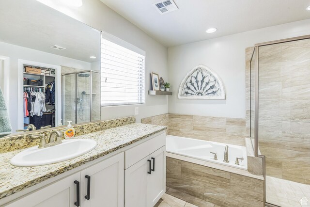 150 N 1100 E Unit 63, Washington, UT 84780 - full bathroom featuring a shower stall, a bath, vanity, a spacious closet, and recessed lighting