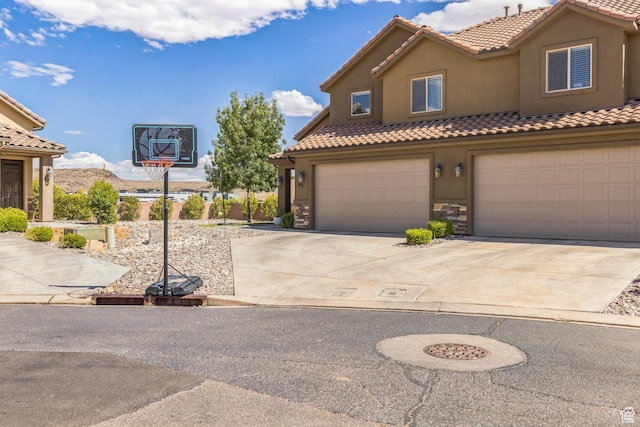 150 N 1100 E Unit 63, Washington, UT 84780 - mediterranean / spanish home with stucco siding, a tiled roof, a garage, driveway, and stone siding