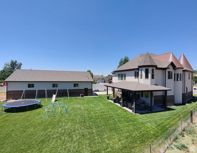 1645 E 6800 S, Uintah, UT 84405 - rear view of house with a trampoline, a patio area, a fenced backyard, and stucco siding