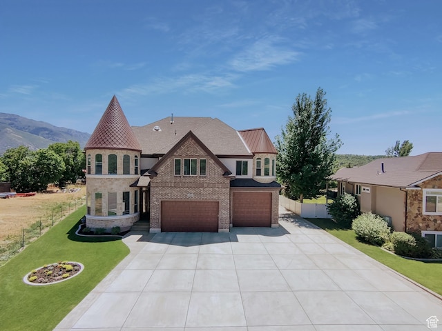 1645 E 6800 S, Uintah, UT 84405 - view of front of house with an attached garage, concrete driveway, brick siding, a mountain view, and stone siding