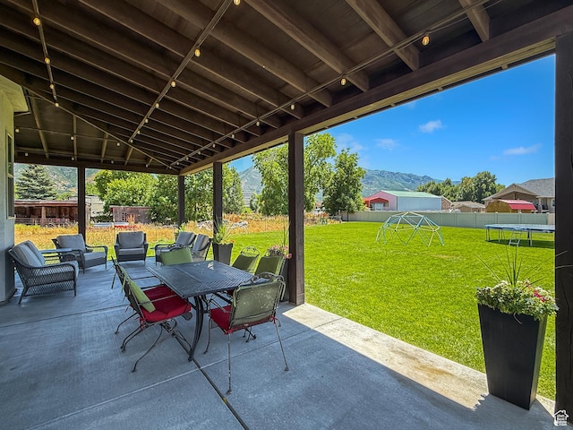 1645 E 6800 S, Uintah, UT 84405 - fenced backyard featuring a trampoline, a patio, outdoor dining area, a playground, and a mountain view