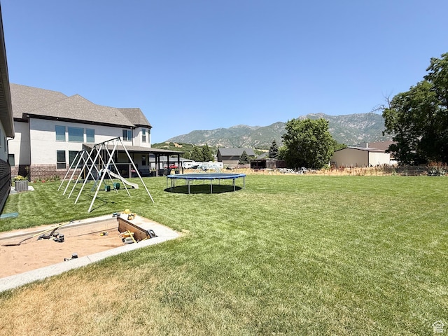 1645 E 6800 S, Uintah, UT 84405 - view of grassy yard with a trampoline, a playground, and a mountain view